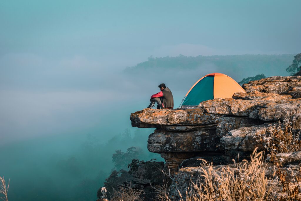man camping on the hill all alone